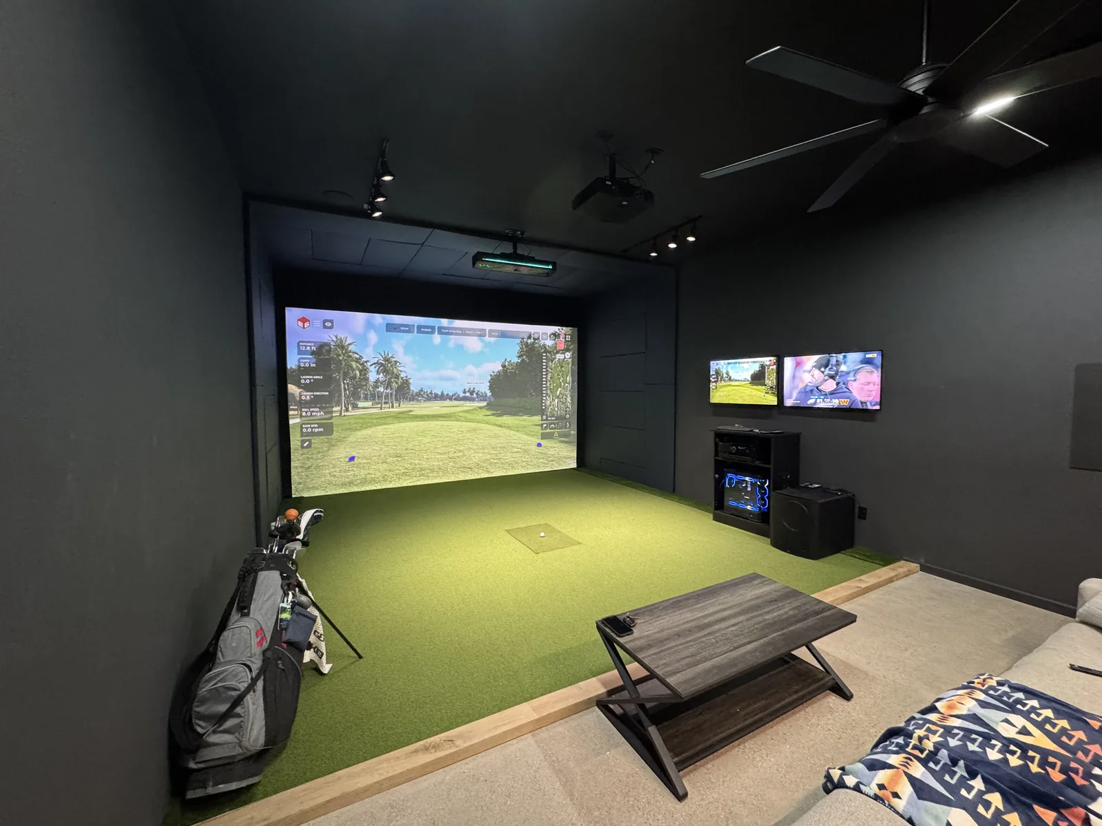Custom home simulator with turf floor and dual screens