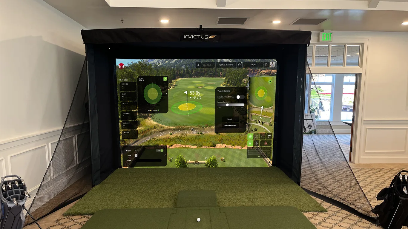 Portable event simulator set up in a clubhouse with turf hitting bay