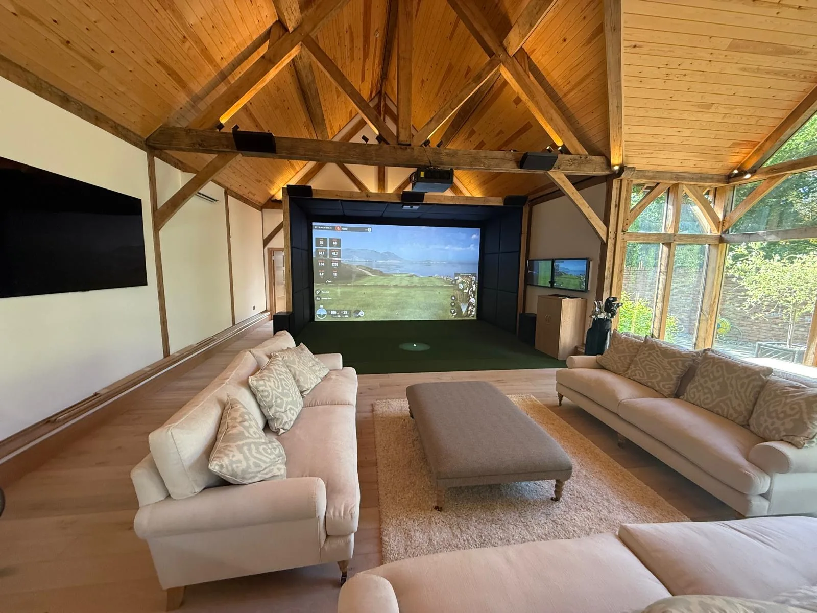 Custom Invictus golf simulator bay with impact screen and turf hitting area